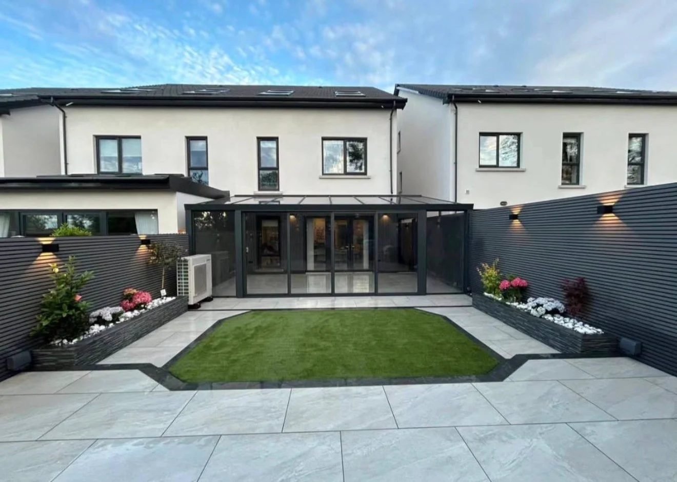 Modern Belfast garden transformation with porcelain paving, artificial lawn and slatted fencing