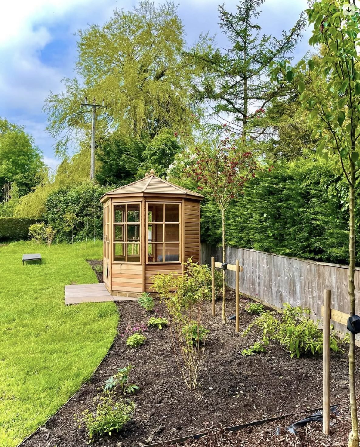 New planting beds and borders around a garden summerhouse